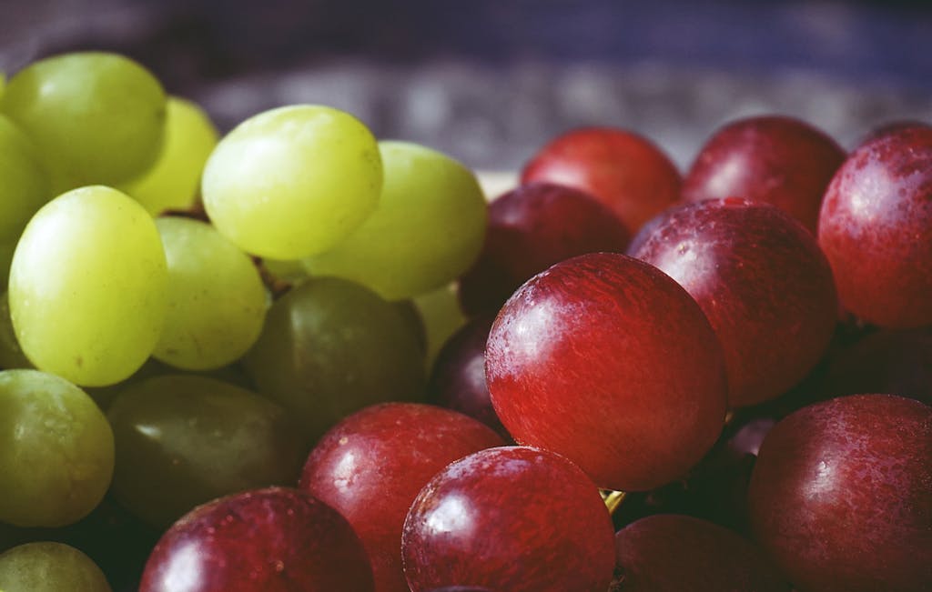 A vibrant close-up of red and green grapes showcasing freshness and vivid colors.